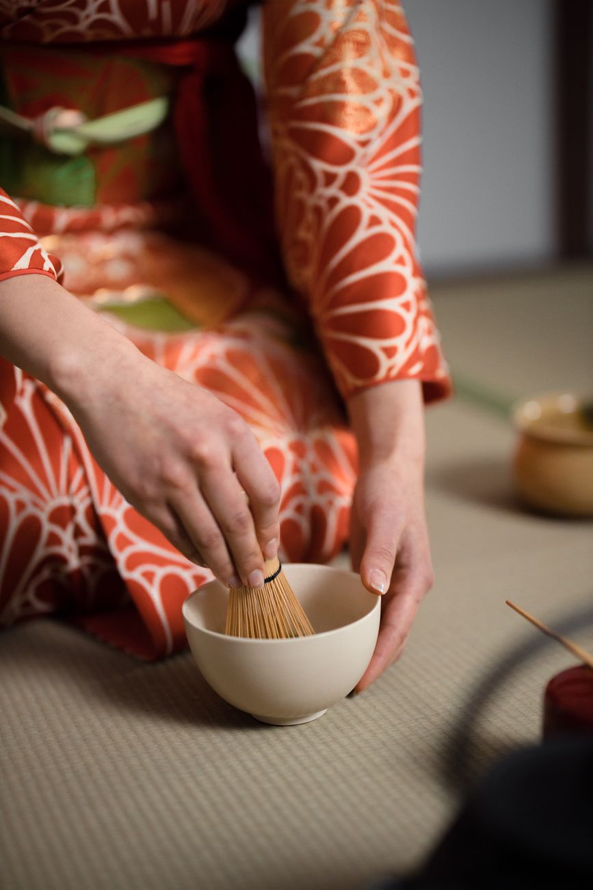 A serene table setup with matcha bowls and ceramic teapots